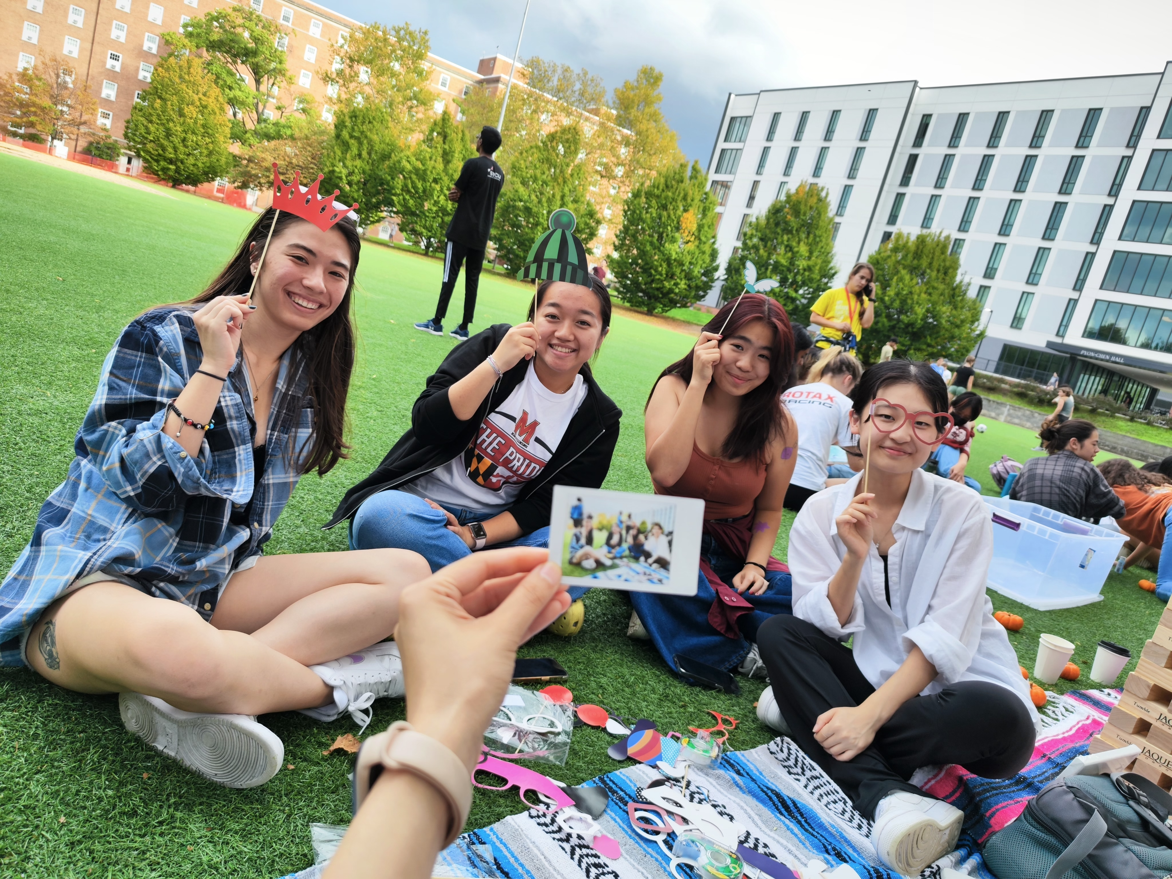 students holding props at picnic