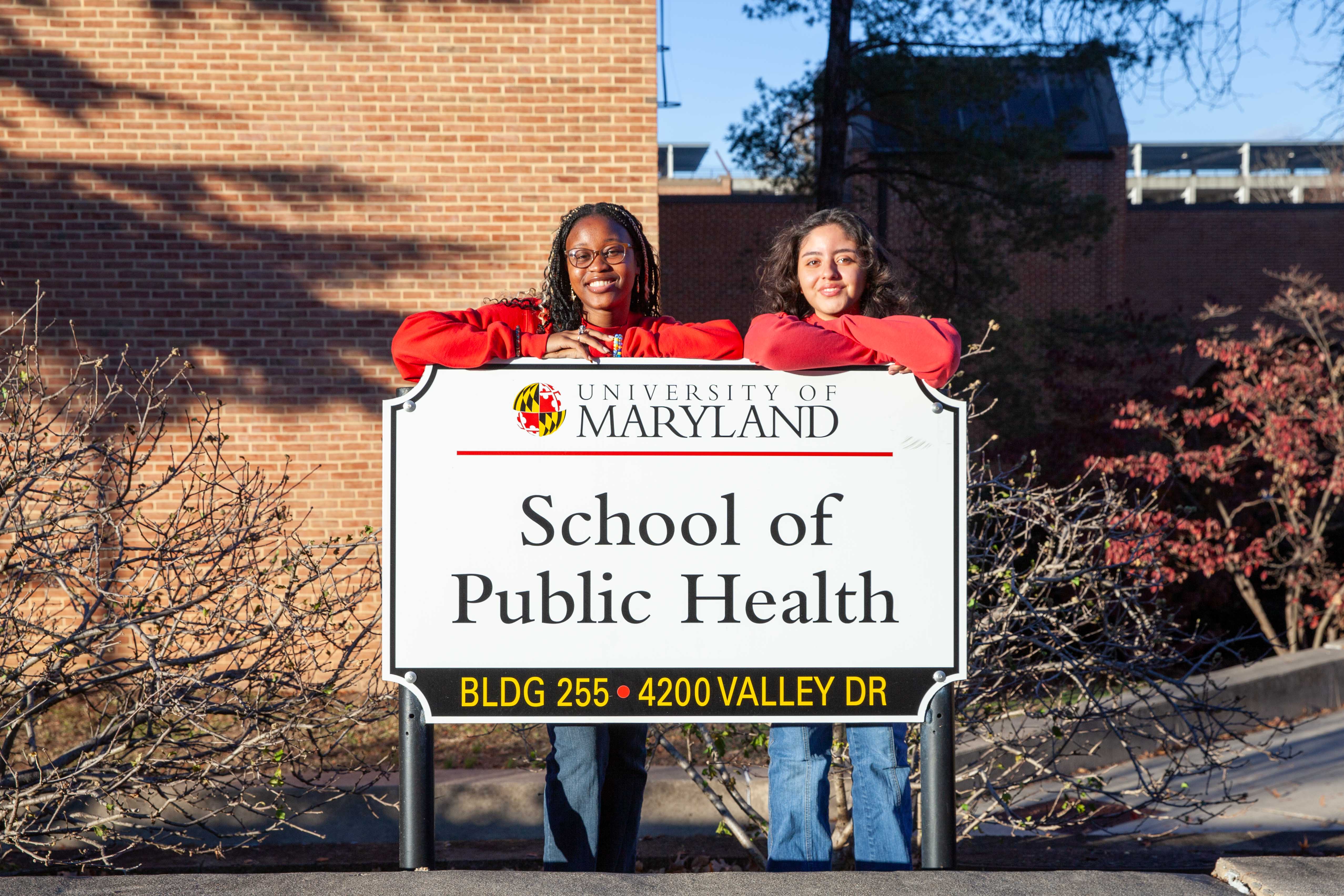 students standing next to sphl sign