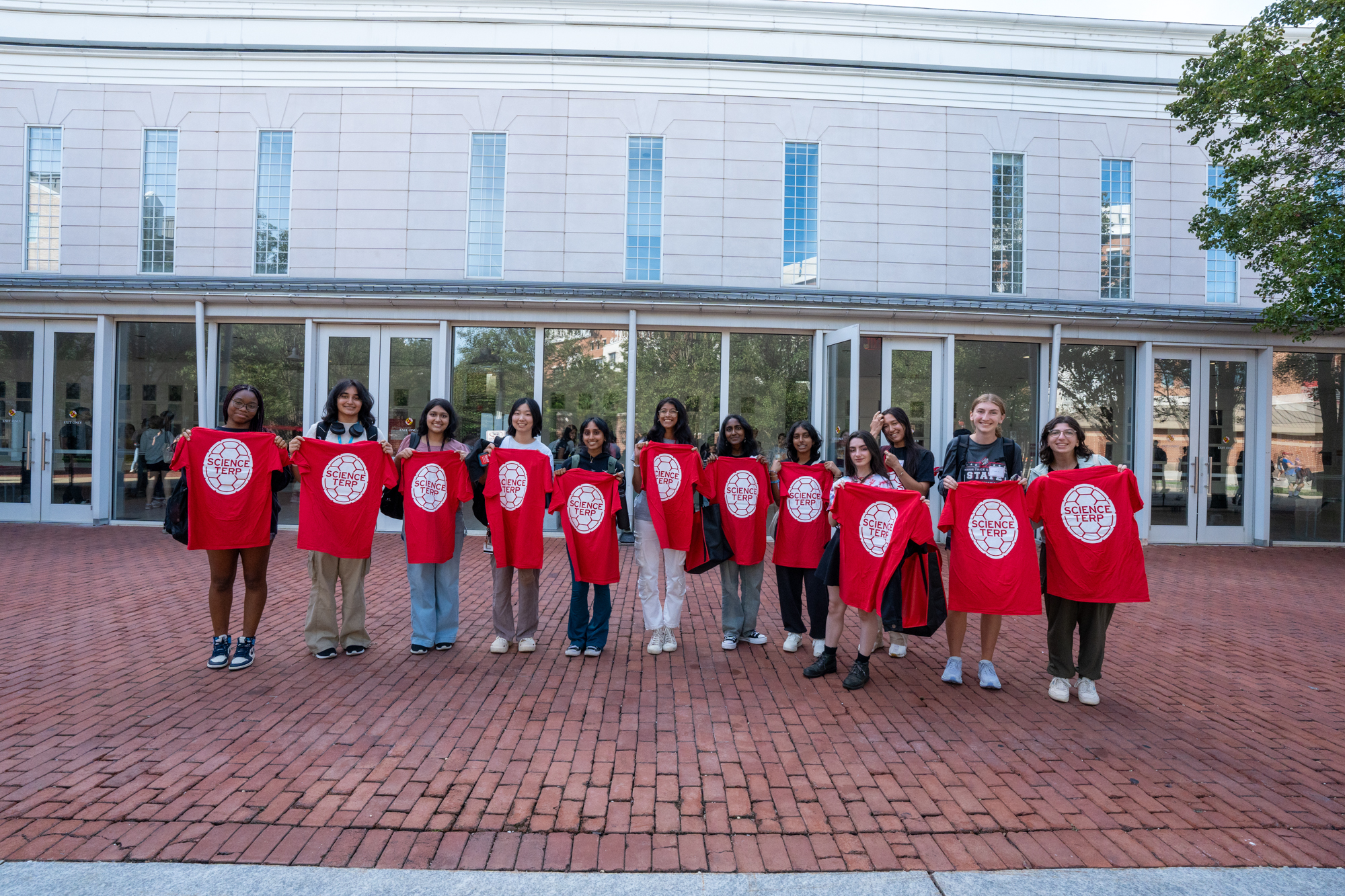 students holding science terps shirts