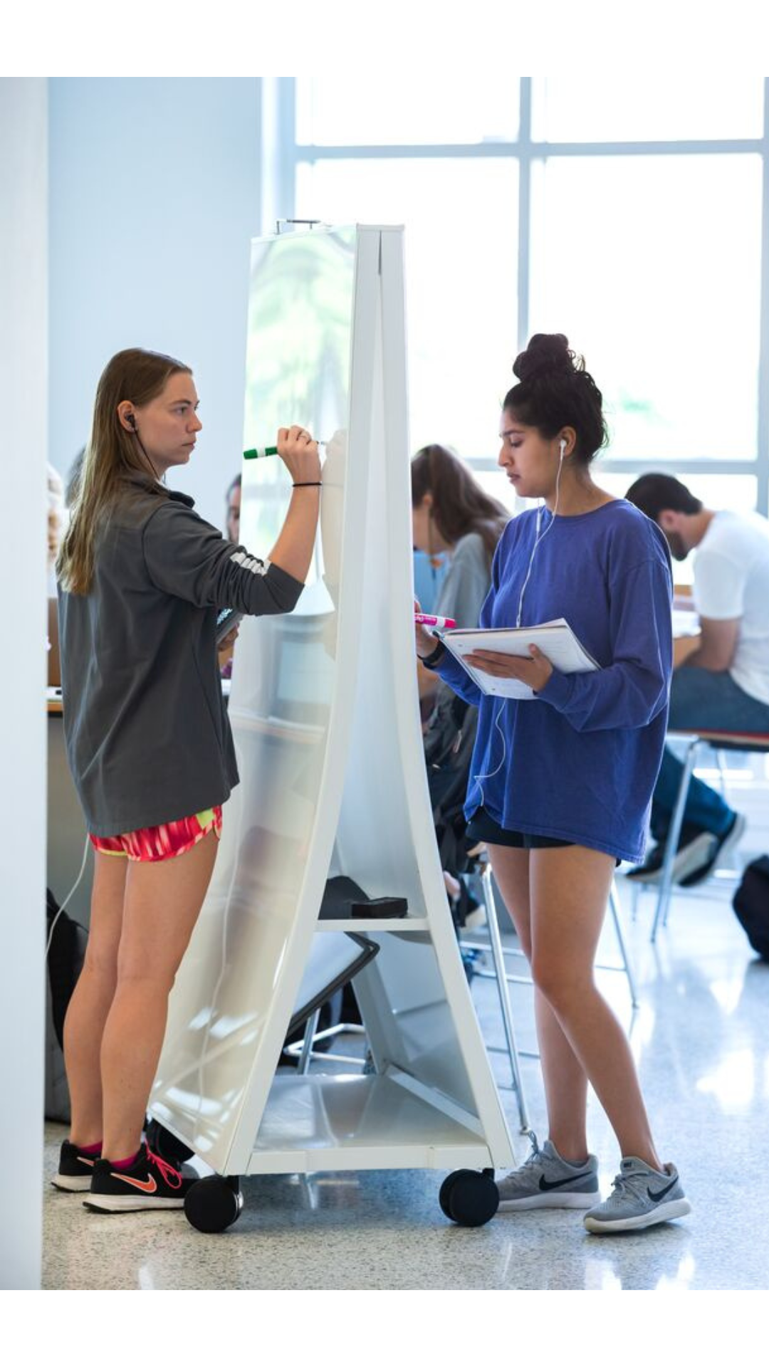 students writing on whiteboards
