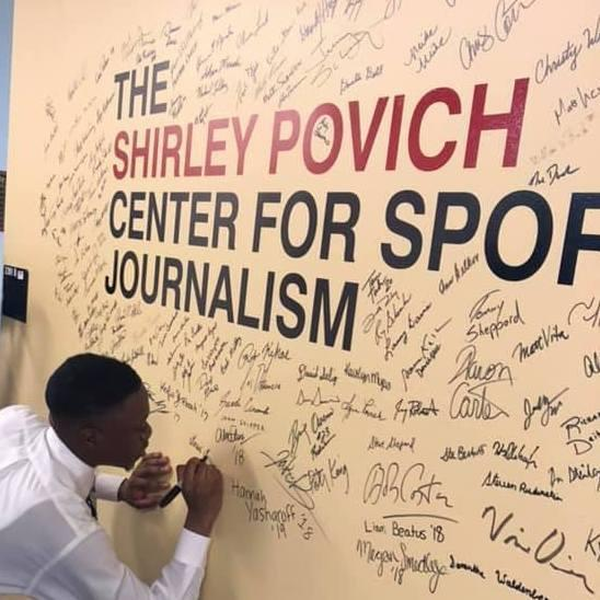 student signing povich center board