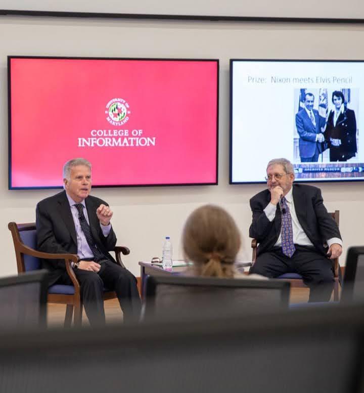 A lecturer speaks with students 