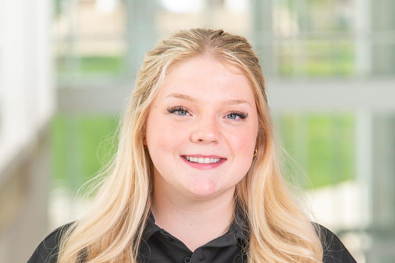 TA Ambassador Emmaline with a black polo on