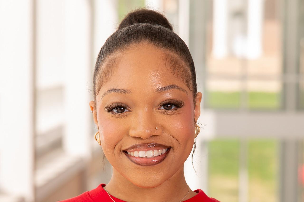 Headshot photo Transition Mentor Amira Hair with a red Maryland t-shirt