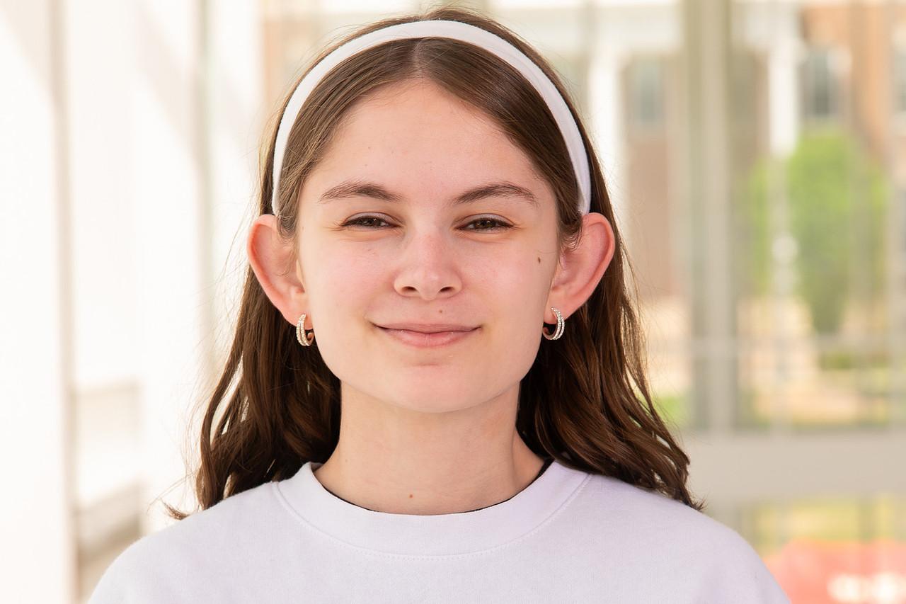 Transition Council Member Biance Lewandowski in a white UMD crewneck and a white headband