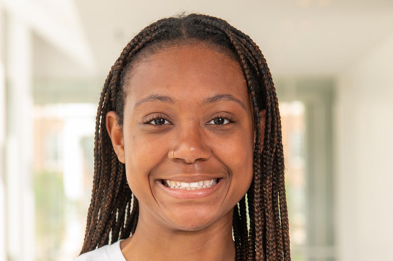 Transition Council Member Caiya Campbell, in a white Maryland T-shirt with a colored Testudo holding the UMD M.