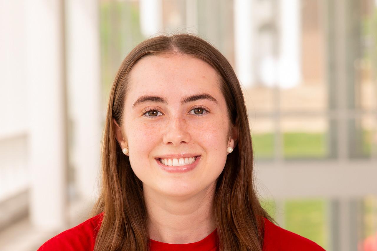 Transition Council Member Gabby Rosati, in a red University of Maryland shirt with yellow lettering and a white Testudo outline.