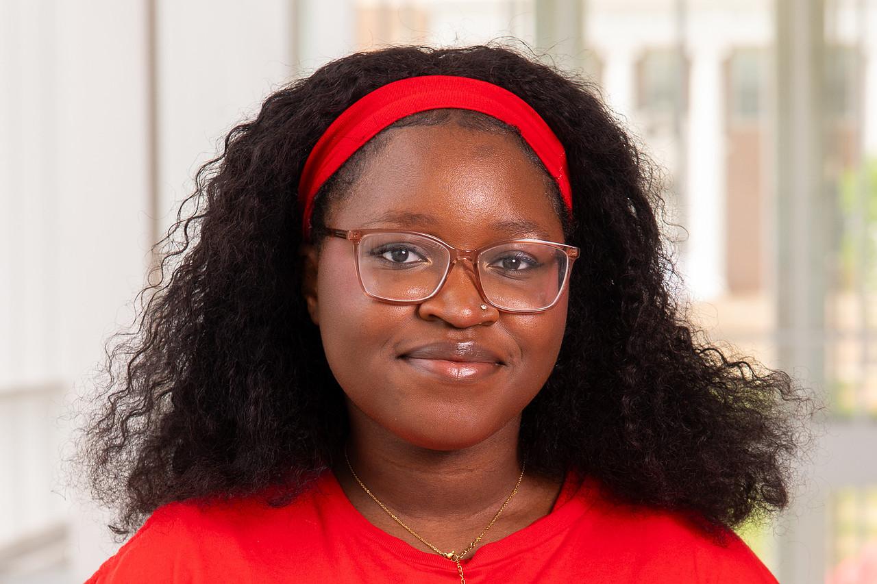 Transition Mentor Helena Solefack Momo in a red UMD t-shirt and a red headband